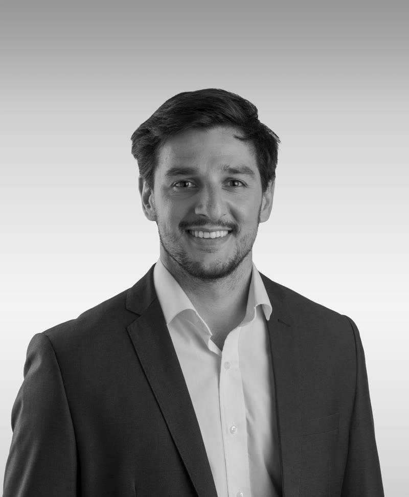 Retrato de Andrés Tiscornia, de saco y camisa blanca, sobre un fondo liso
